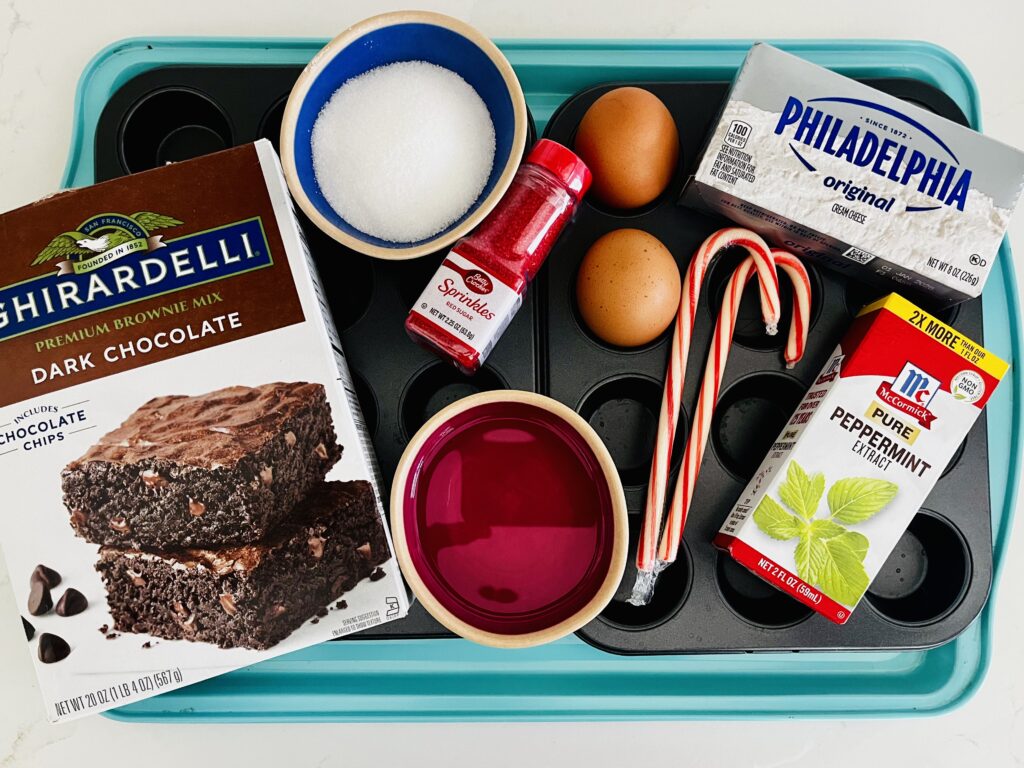 Ghirardelli dark chocolate brownie mix, vegetable oil, eggs, cream cheese-Philadelphia brand used, granulated white sugar, peppermint extract ,candy canes and decorative red sugar on a mini muffin tin.