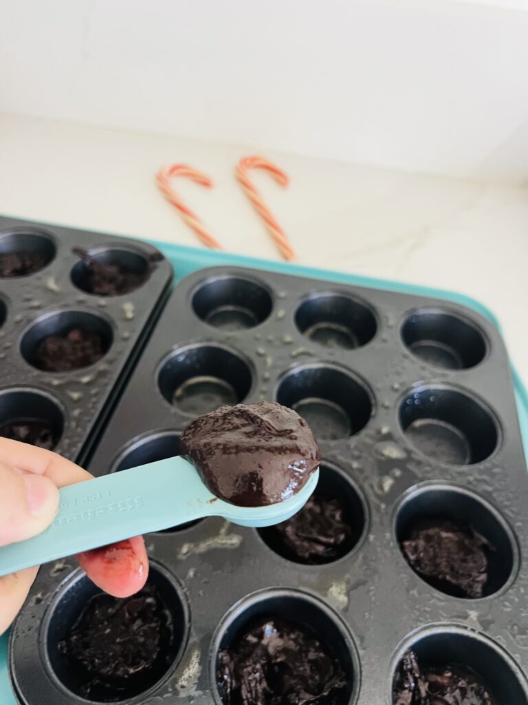  A heaping tsp of brownie batter in a teaspoon measuring spoon.