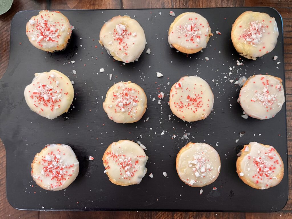 Decorated mini brownie bites with crushed candy canes and red sugar.