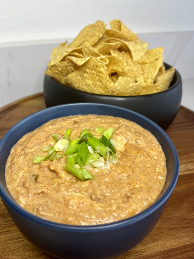 Best Refried Bean Dip and tortilla chips on a tray on the counter