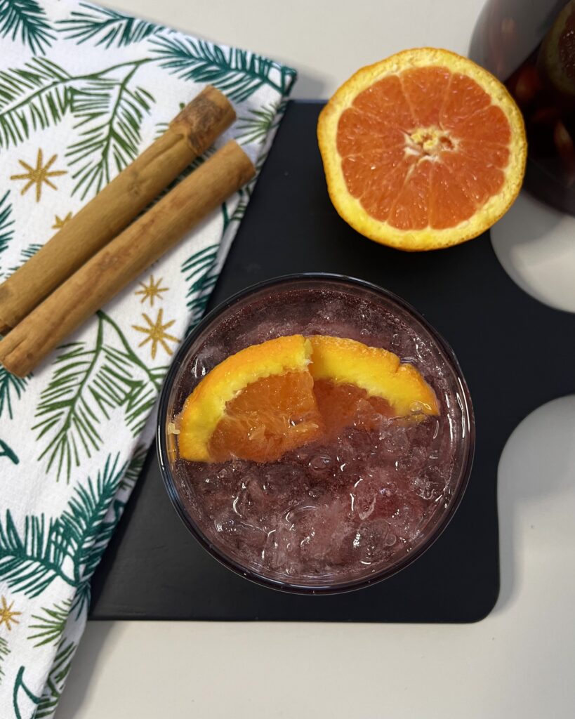 Festive Fizzy Sangria on a black cutting board on the counter.