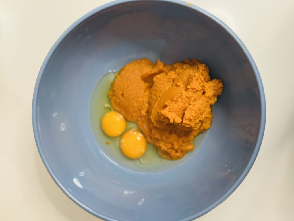 eggs and pumpkin in a large blue bowl on the counter