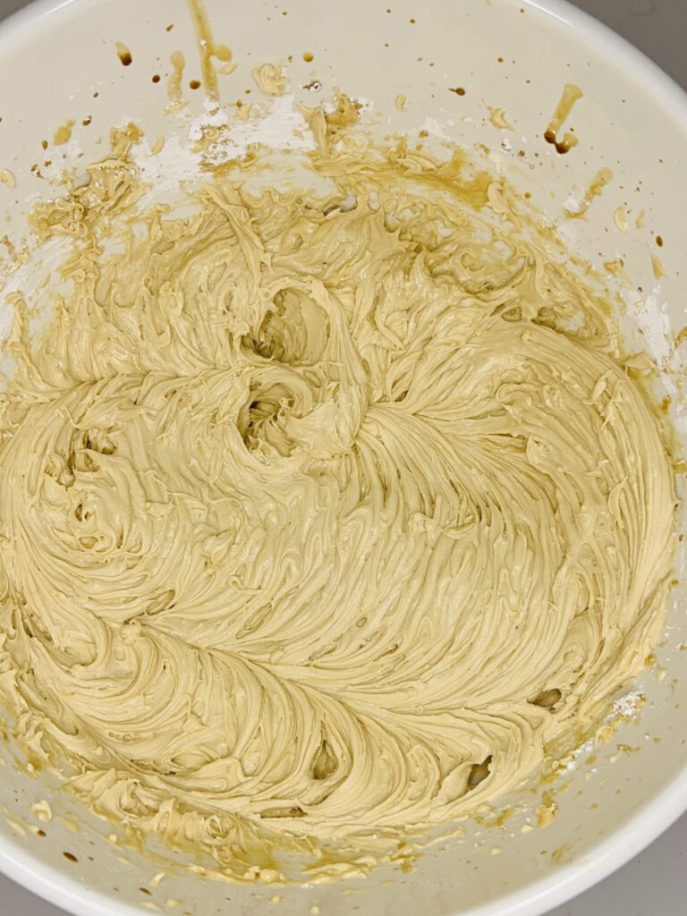 Mixed cappuccino frosting in a large white bowl on the counter