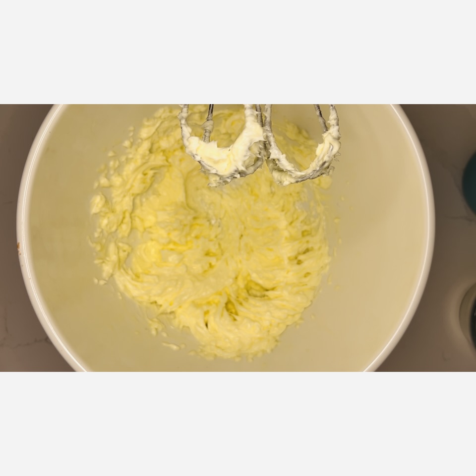 Creamed butter in a large white bowl on the counter.