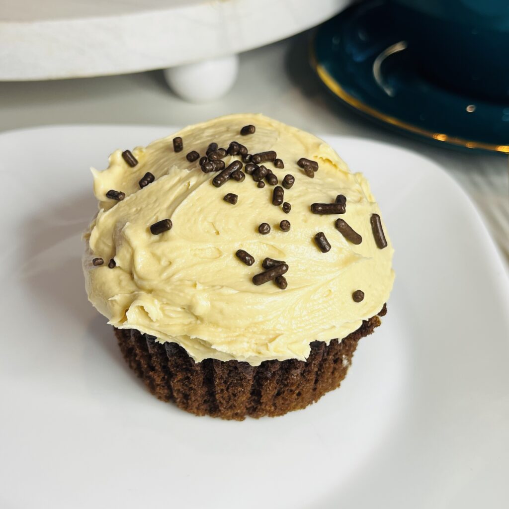 Cappuccino Frosted Cupcake on a white plate on the counter