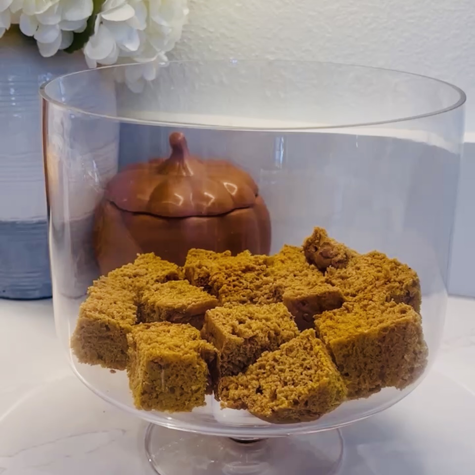 cake pieces in glass trifle container on the counter.