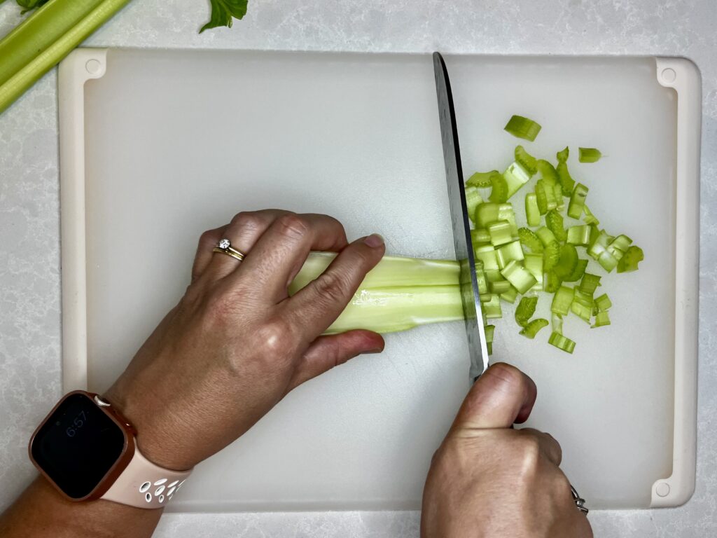 celery being chopped straight across