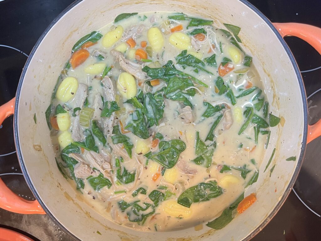 a pot of cooked chicken and gnocchi soup