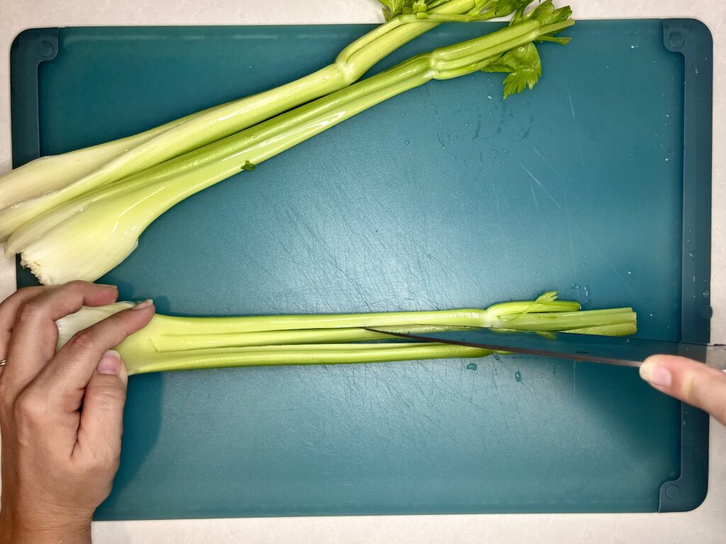 celery being sliced vertically