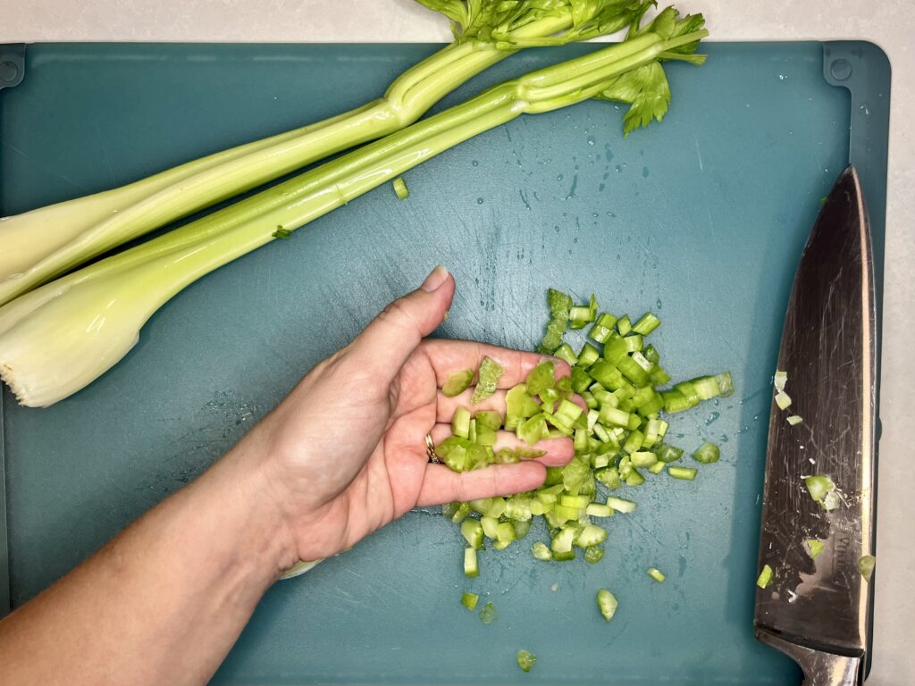 small pieces of celery on a cutting board