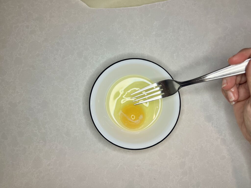 egg and water in a bowl with a fork