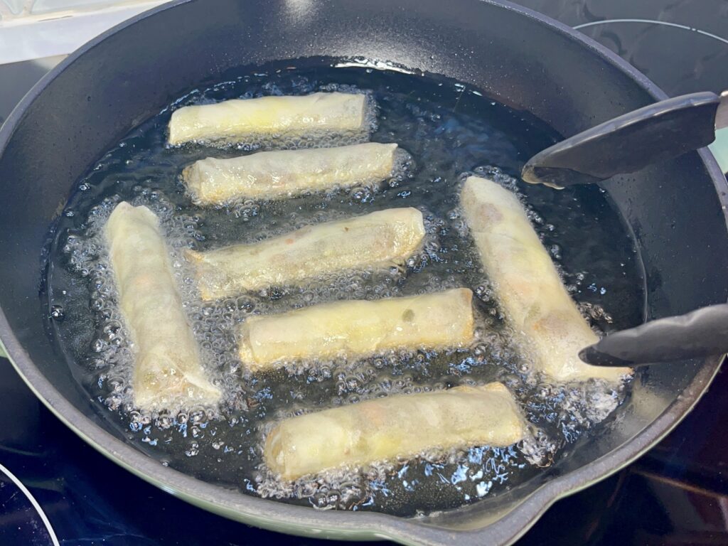 lumpia in a pan with hot oil