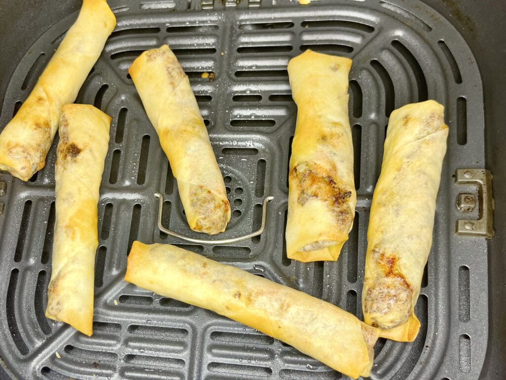 cooked lumpia in an air fryer basket