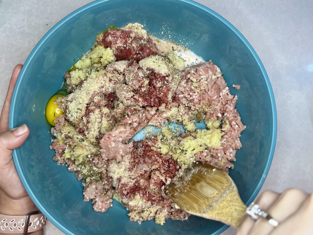 meatball ingredients being stirred in a bowl