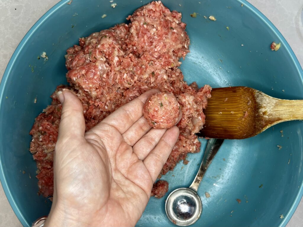 a tablespoon of the meatball mixture rolled into a ball