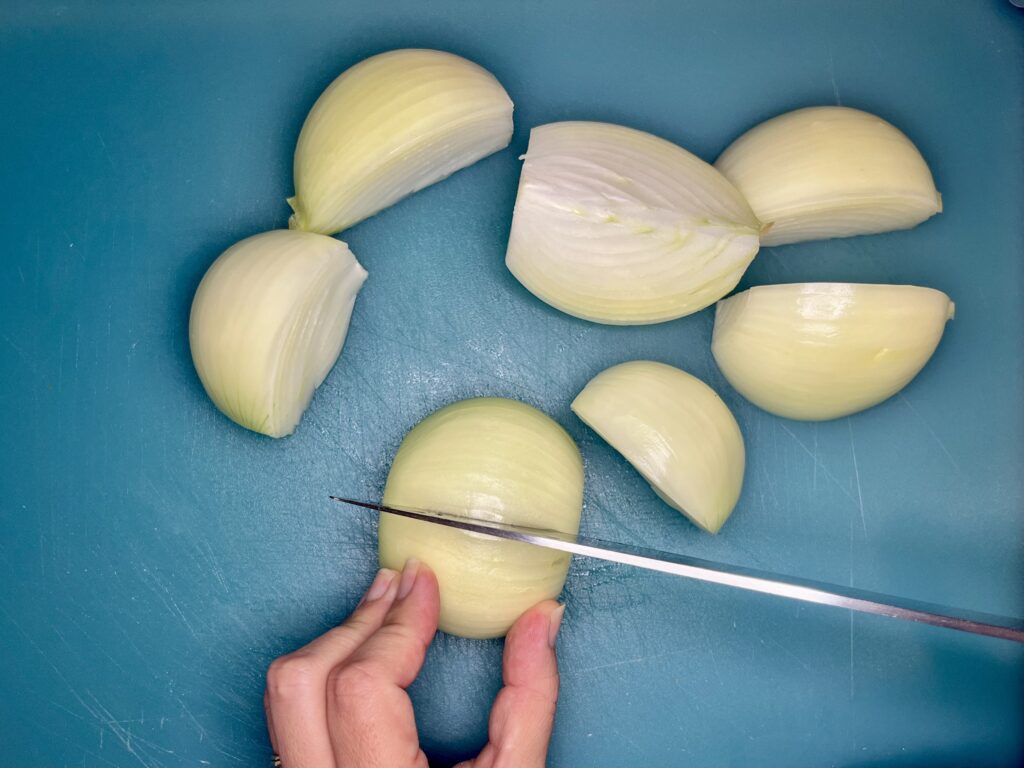 yellow onions being quartered