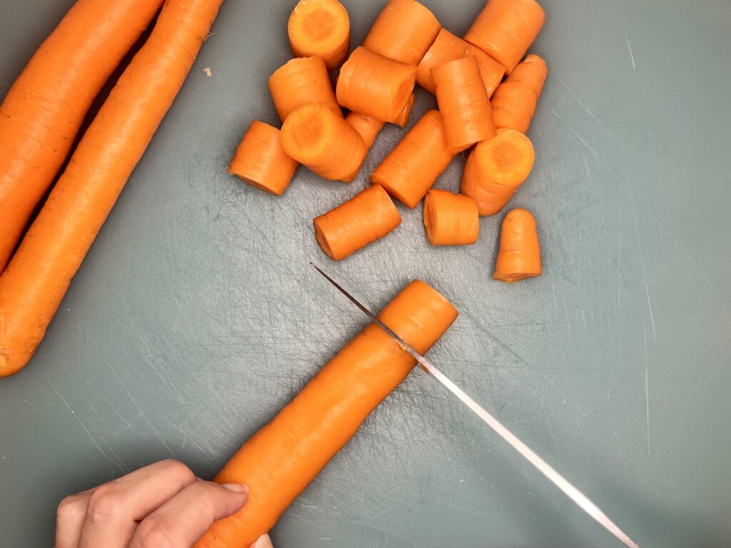 celery being sliced into 1 inch sections