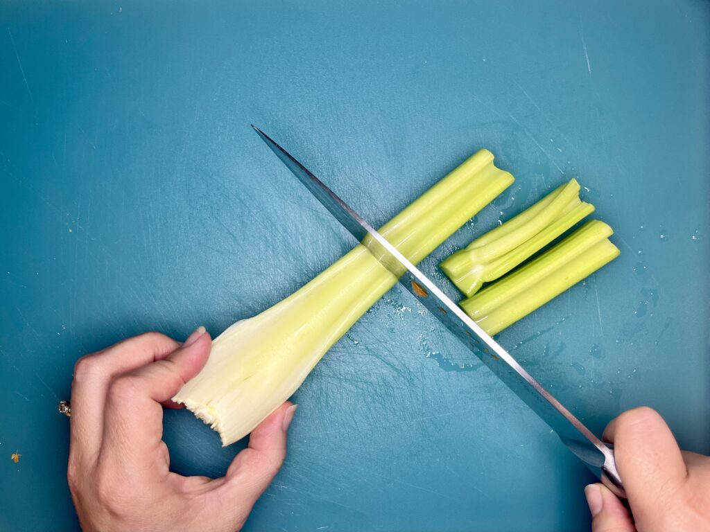 Celery being sliced into pieces