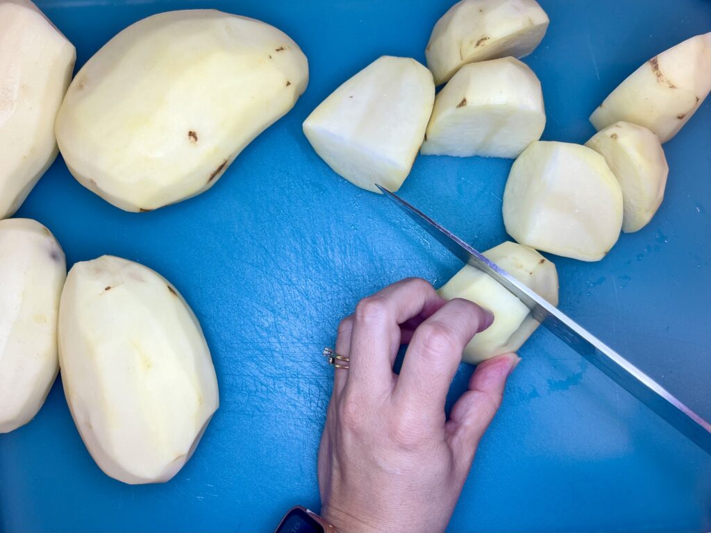 a potato half being cut in two