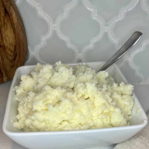 a bowl of cooked mashed potatoes on a counter