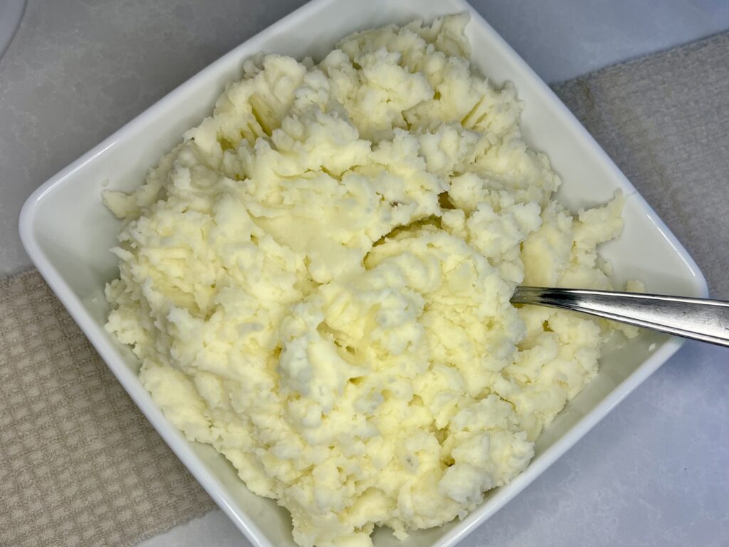 a bowl of cooked mashed potatoes