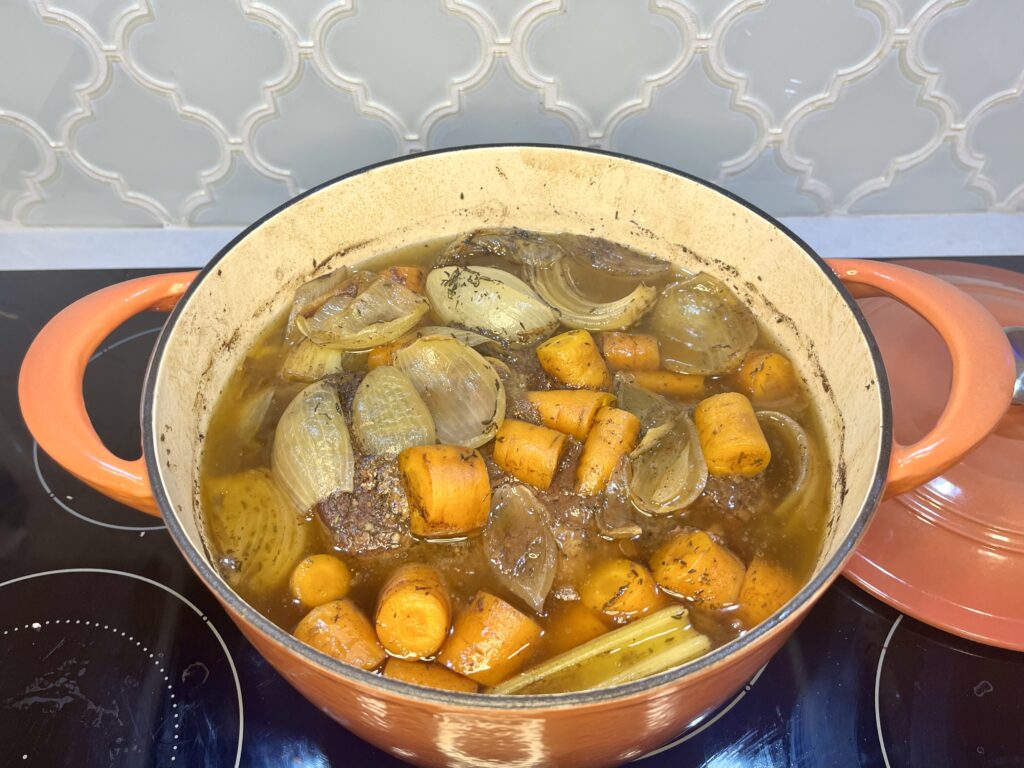 a pot filled with cooked beef and vegetables