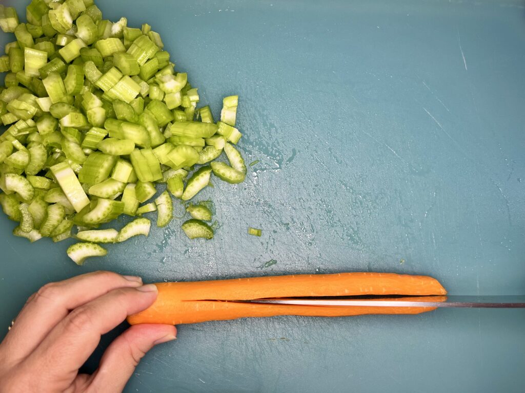 a carrot being sliced vertically