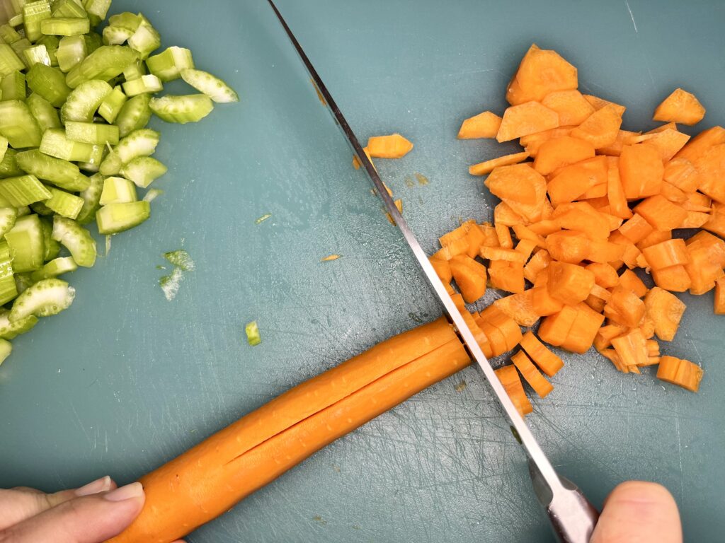 a carrot being chopped up