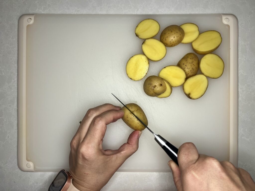 baby potatoes being cut in half