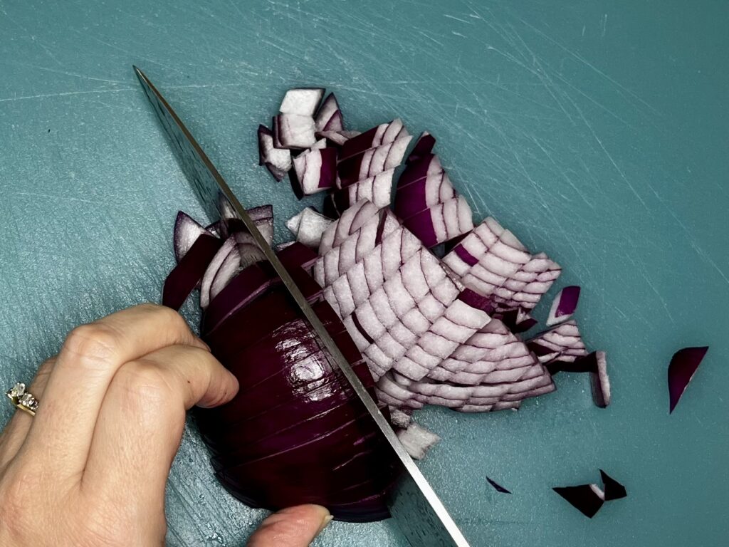 a knife dicing red onion