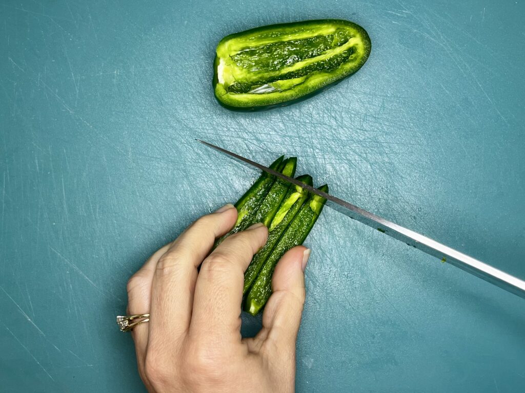 a knife dicing jalapeno 