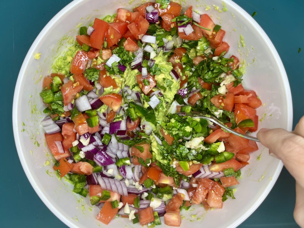 vegetables being stirred in to avocados