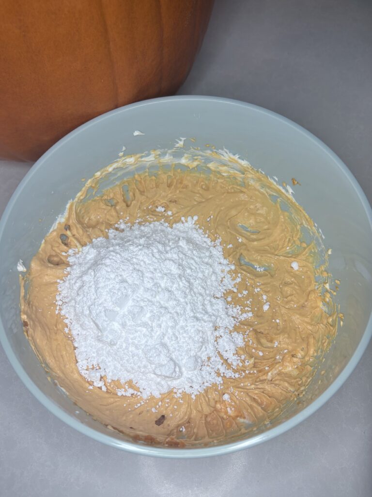 powdered sugar added to pumpkin mixture in a bowl