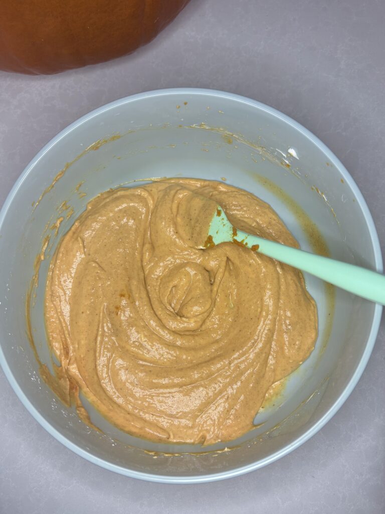 pumpkin dip being stirred with a spatula