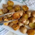 Crispy baked Parmesan potatoes on a white platter, golden and seasoned, perfect for a delicious side dish or snack.