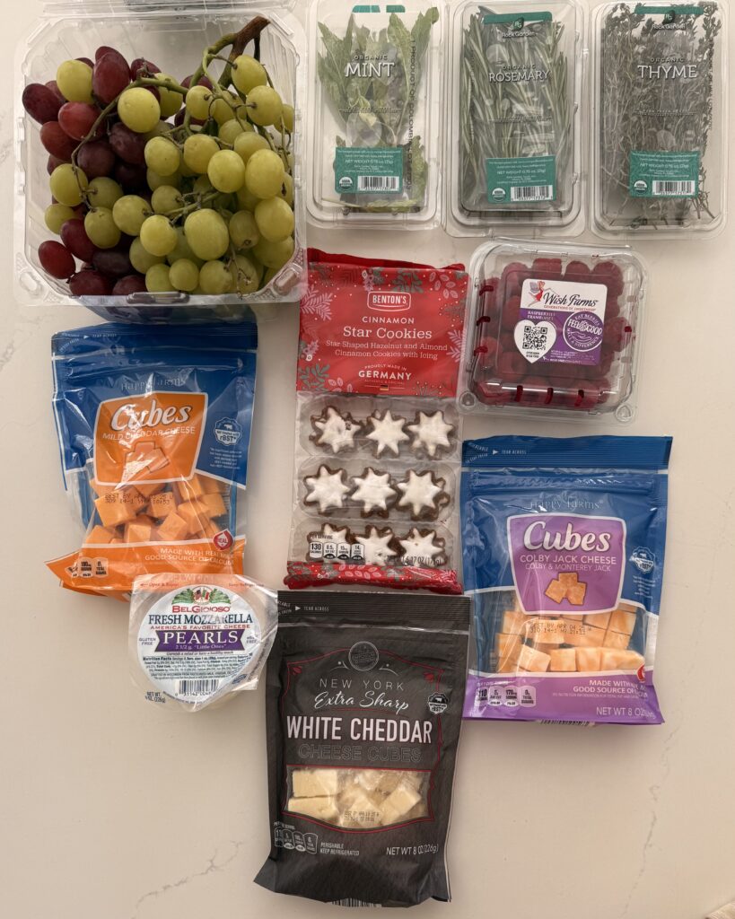 crackers-any kind & optional

sprigs of rosemary, sprigs of thyme and mint leaves, cheddar cheese cubes- different kinds, star cookies, red and green grapes, and raspberries