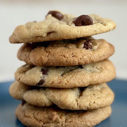 A stack of chocolate chip cookies on a blue plate