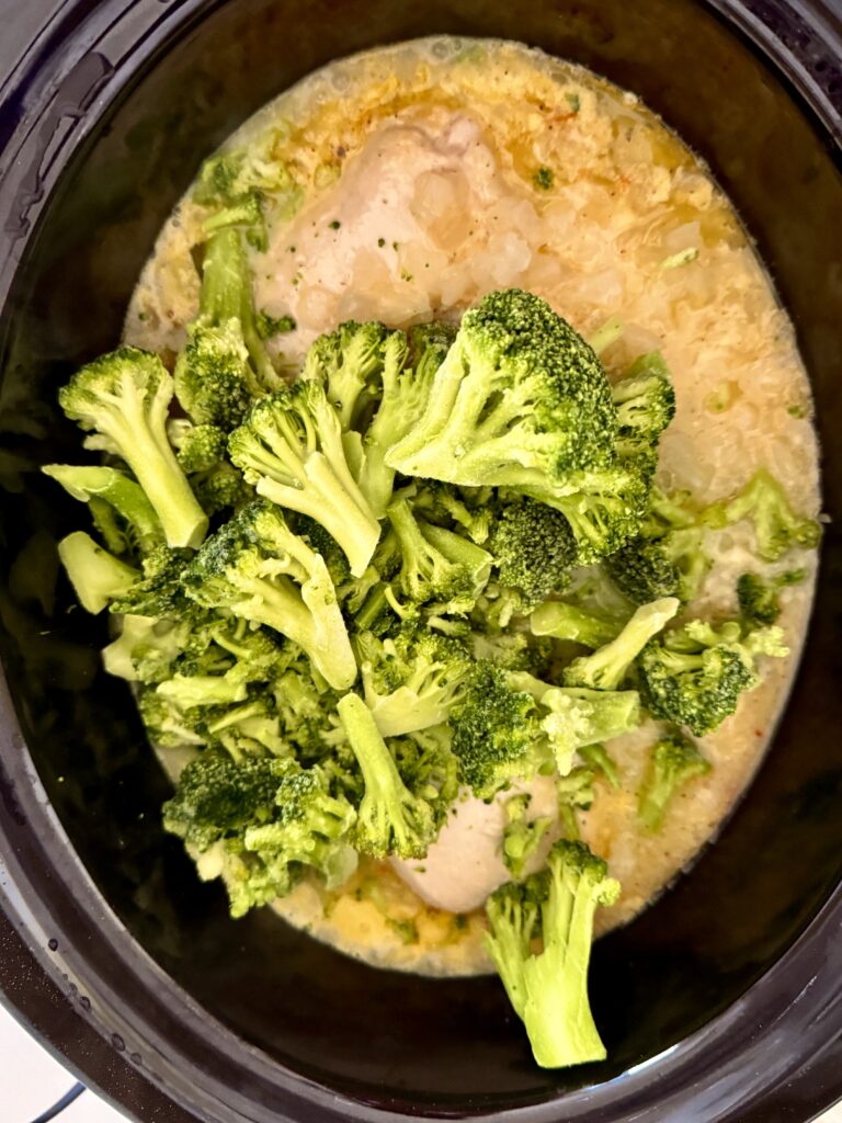 Frozen broccoli in the slow cooker on the counter.