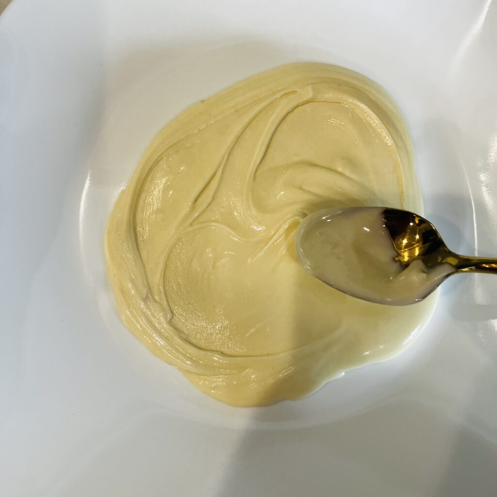 melted white chocolate on a white plate on the counter.