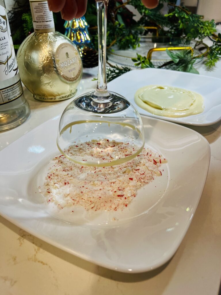 coupe glass and crushed candy on a white plate on the counter