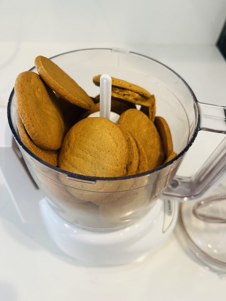 ginger snap cookies in a small food processor on the white kitchen counter