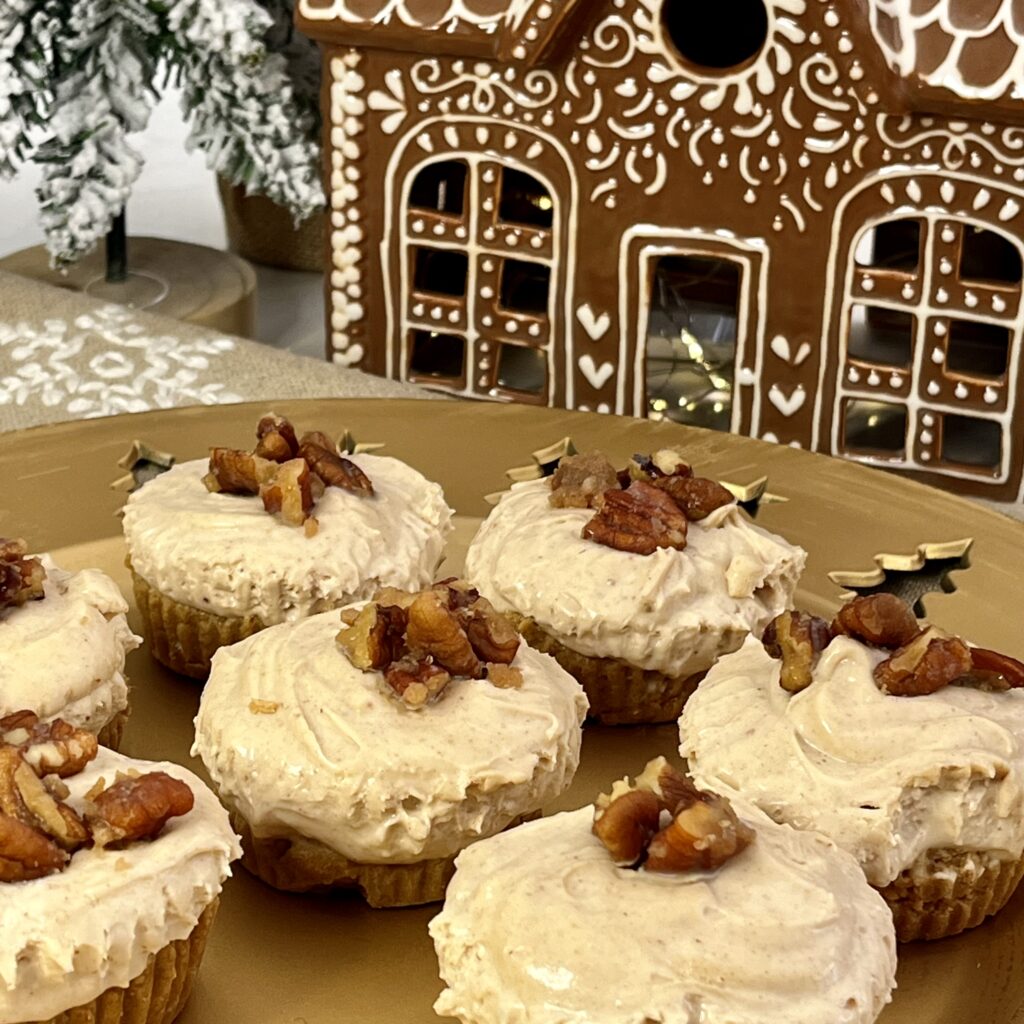 mini gingerbread cheesecakes topped with candied pecans on a good platter on the white counter