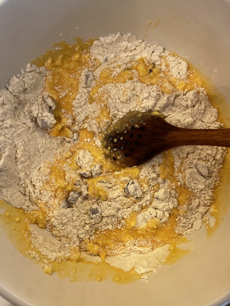 mixed dry and wet ingredients in a large white bowl on the counter