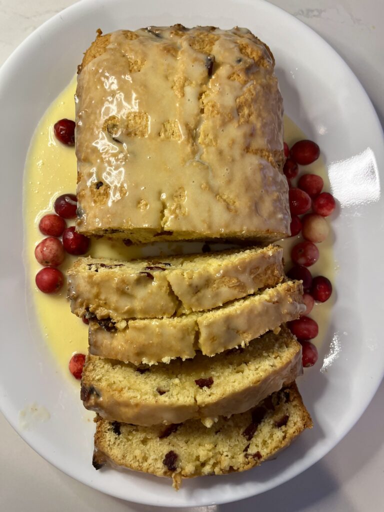 cranberry and eggnog loaf on a plate on the counter