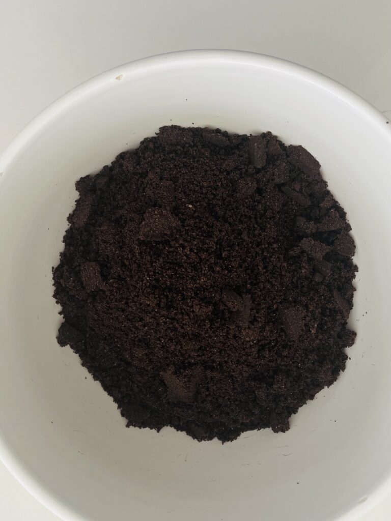 Oreo cookie crumbs in a large mixing bowl on the counter