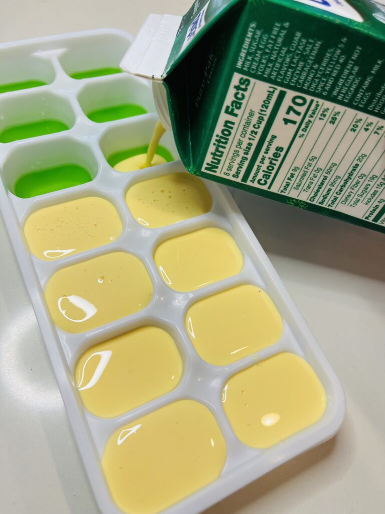 Pouring eggnog into ice cube tray and the counter