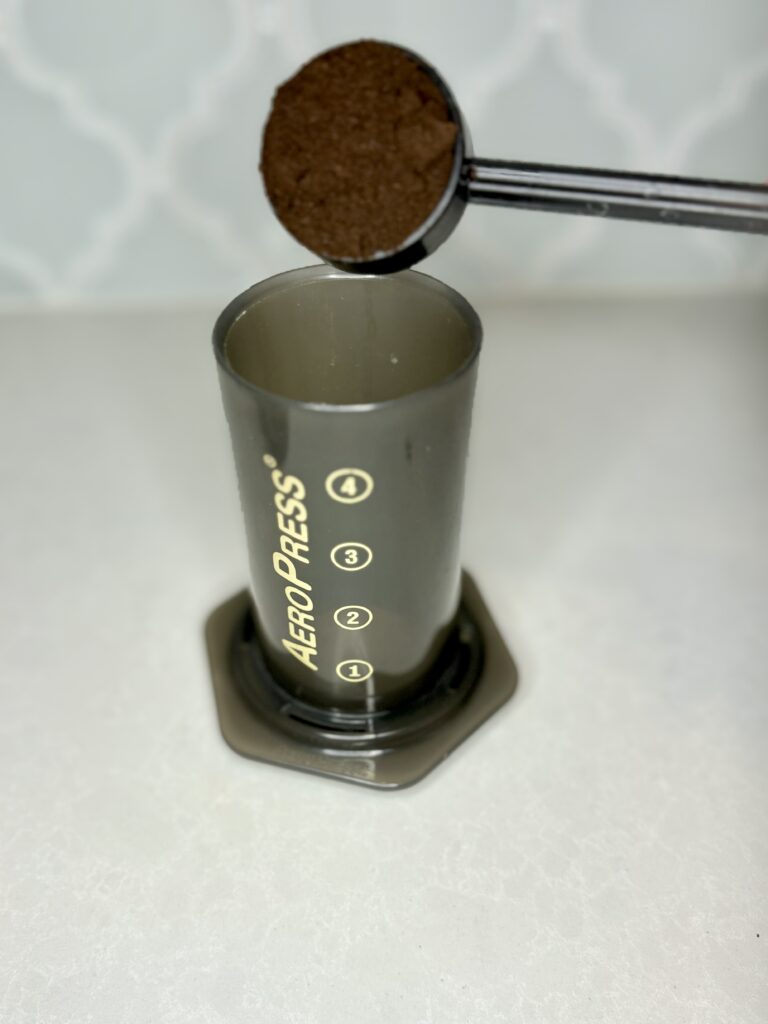 coffee grounds being added to AeroPress