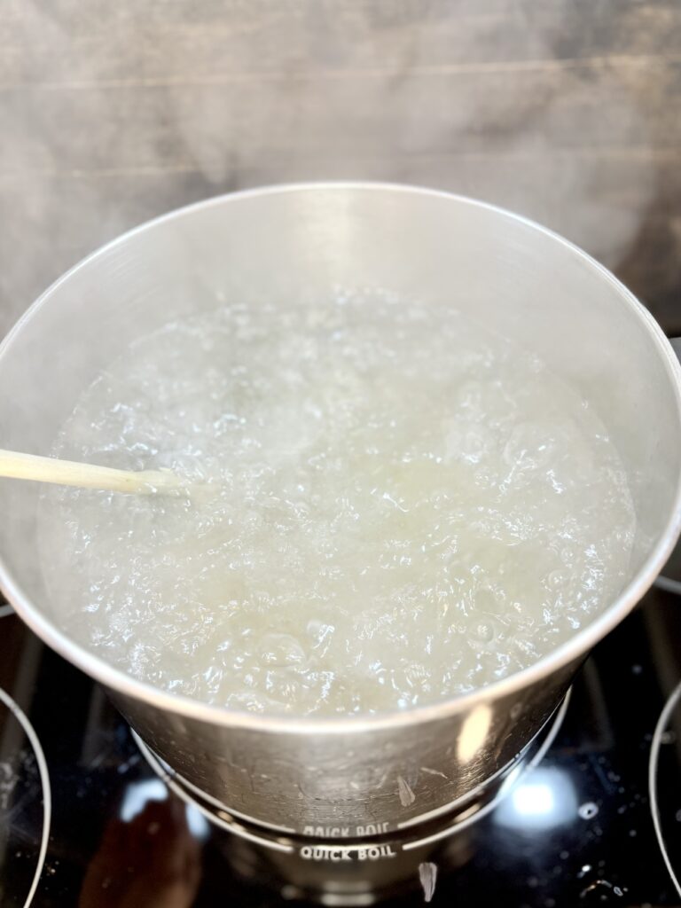 pasta being stirred in boiling water