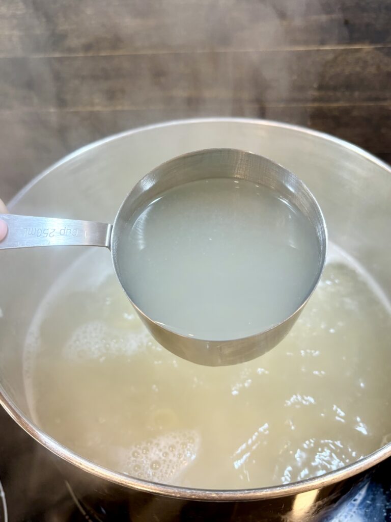 reserved pasta water in a measuring cup