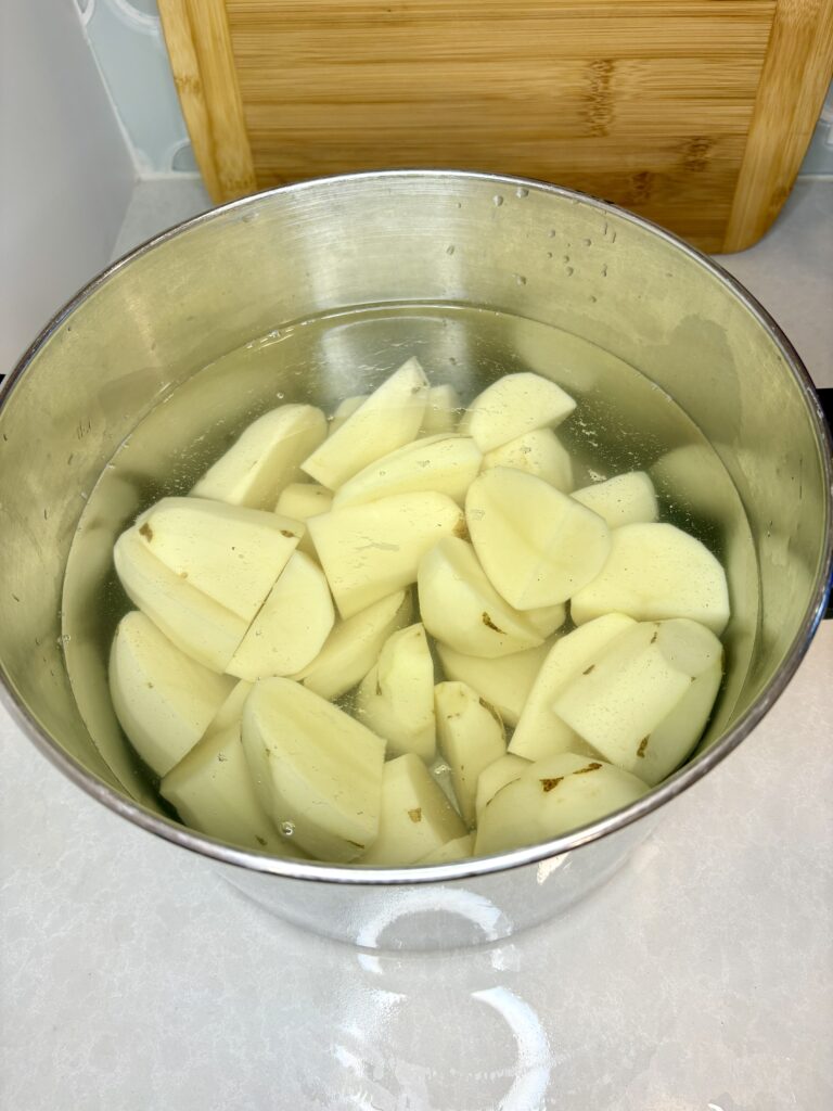 cut potatoes in a pot filled with water